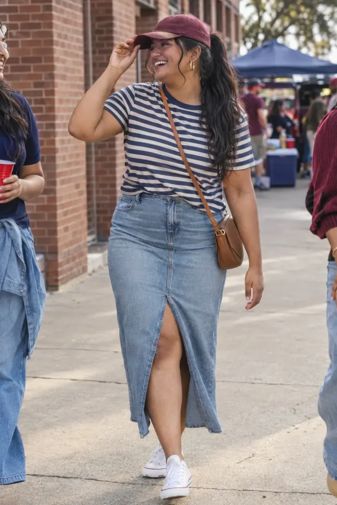 Plus size tailgate outfit with a denim midi skirt and striped tee for warm fall weather