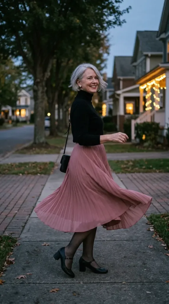 Dusty rose pleated midi skirt with black turtleneck, comfortable Valentine dinner outfit for curvy women